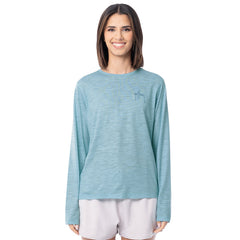 Woman wearing a light blue long-sleeve shirt with a small logo on a white background