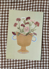 An art print of a painting of queen anne's lace in a planter, on sage green background.