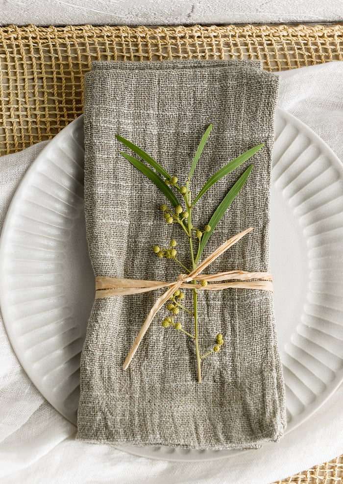 A napkin on a fluted plate.