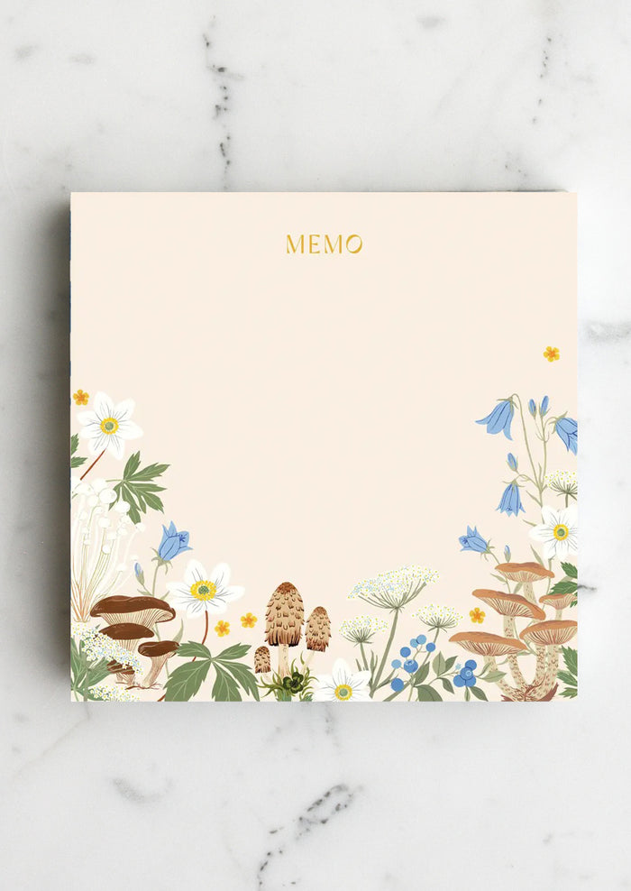 A chunky square notepad reading "MEMO" at top with mushroom floral print at bottom.