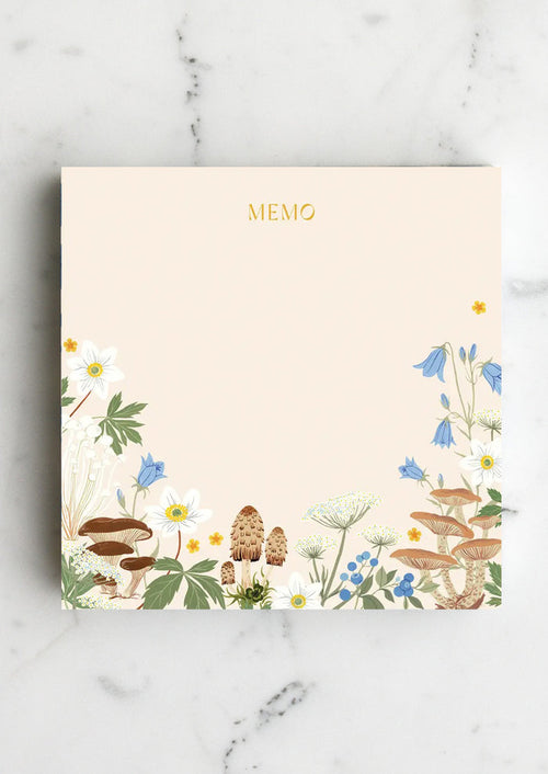 A chunky square notepad reading "MEMO" at top with mushroom floral print at bottom.