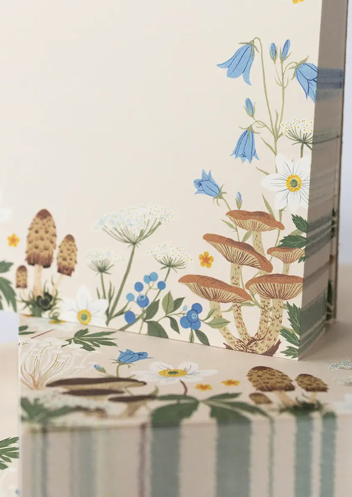 A chunky square notepad reading "MEMO" at top with mushroom floral print at bottom.