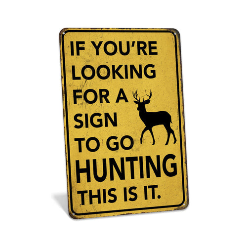 Rustic yellow metal hunting sign reading If You're Looking for a Sign to Go Hunting This Is It with deer silhouette