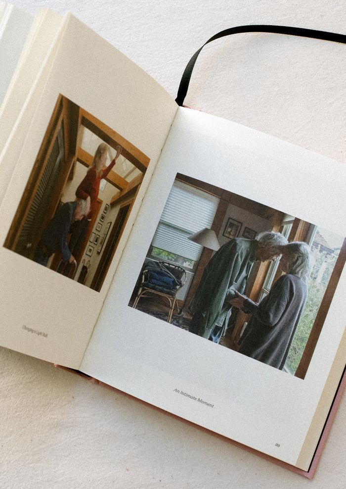 A page in a book showing a photograph of an elderly couple sharing an intimate moment.