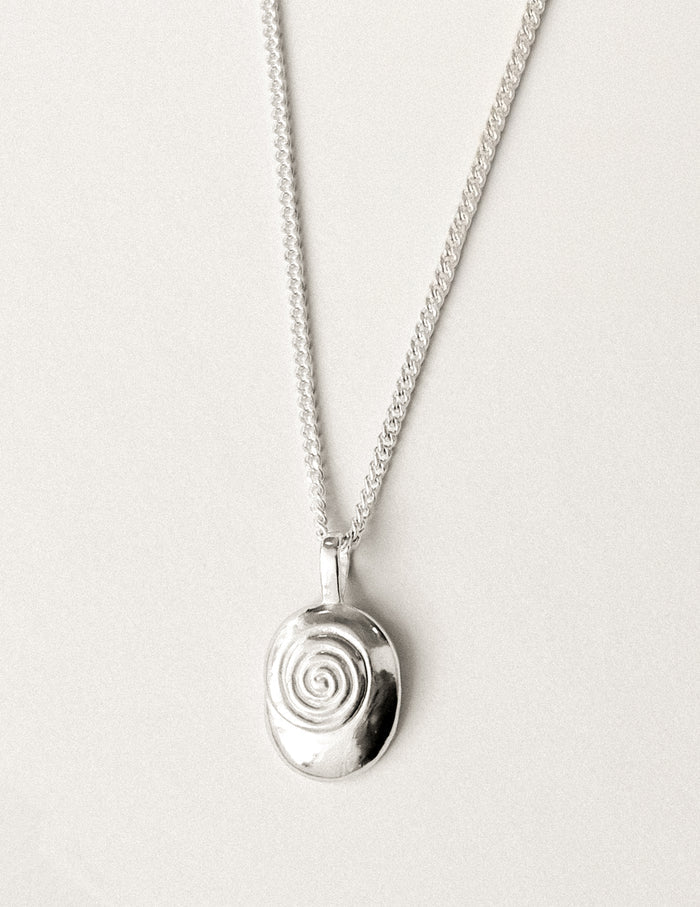 A sterling silver necklace with nautilus shaped pendant.