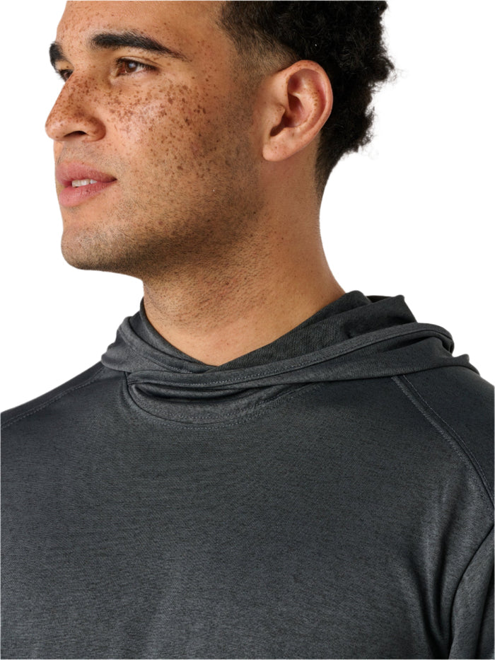 Man wearing a dark gray hoodie against a plain background