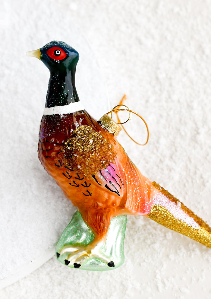 A holiday ornament of a pheasant bird.